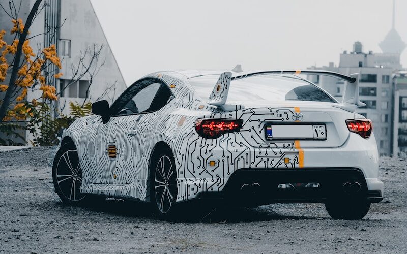 a white sports car parked in a parking lot